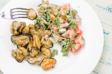 Fried mussels with fresh vegetable salad.