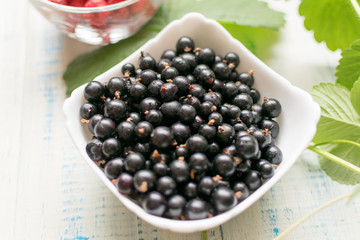 Black currant in a white plate.