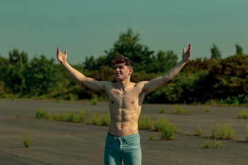 Fototapeta na wymiar Young adult male shirtless outdoors