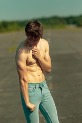 Fototapeta premium Young adult male shirtless outdoors