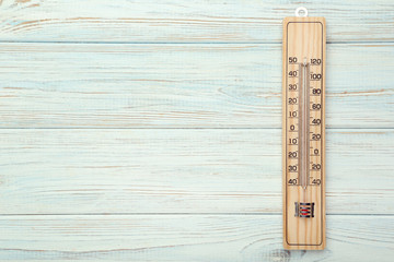 Wooden thermometer on white table