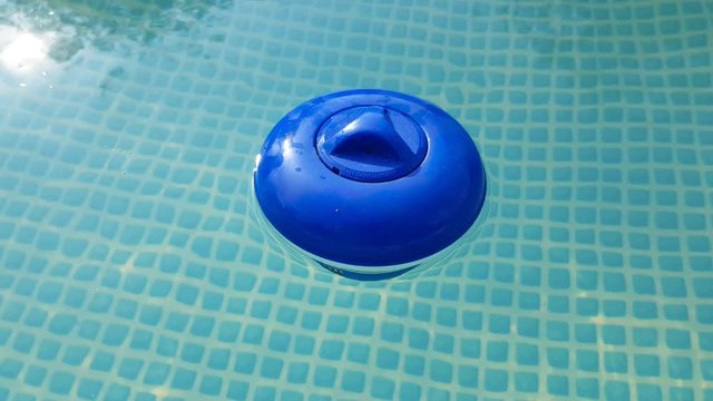 blue plastic cleaning filter in the pool with water