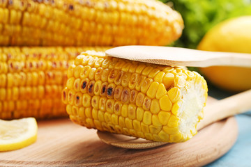 Tasty grilled corns on cutting board