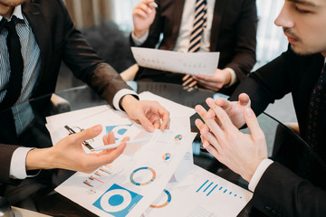 office meeting. business team brainstorming. group of workers study documents with graphs and diagrams. information analysis