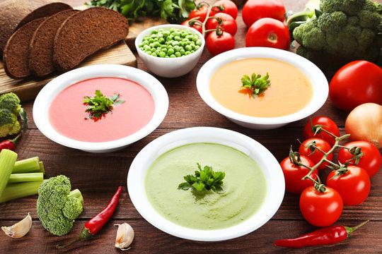 Vegetable cream soup with parsley on wooden table