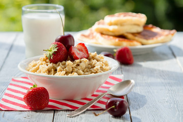 summer berry Breakfast with oatmeal in nature