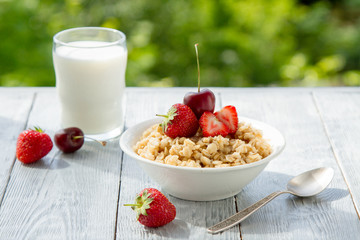 summer berry Breakfast with oatmeal in nature
