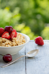 summer berry Breakfast with oatmeal in nature