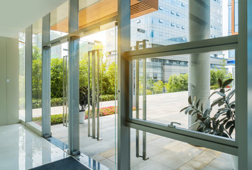 A modern office building with glass doors and windows