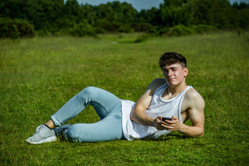 Fototapeta premium A young adult male sitting outside on a summer's day