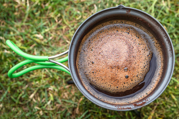 Making morning coffee in tent while hiking in Iceland