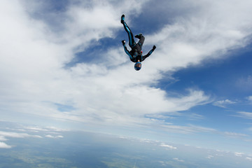Fototapeta na wymiar Freefly skydiving. Girl is falling is a headdown position.