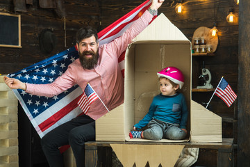 Dream about career of cosmonaut. Family and childhood. Patriotism and freedom. Travel and adventure. Happy independence day of the usa. Father and small boy in paper rocket with American flag