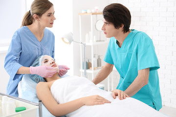Professional beautician teaching trainee in salon. Apprenticeship concept