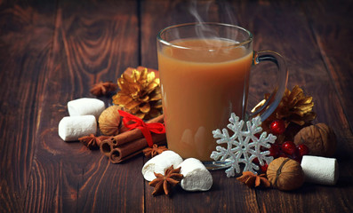 Hot chocolate with marshmallows and cinnamon . christmas decorations on a  old wooden background. Christmas background.