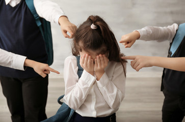 Children bullying their classmate indoors