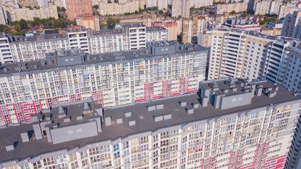 A low angle shot of a new colorful high rise apartment against the sky.