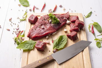 Raw beef on white wood background