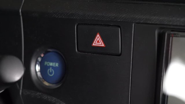 Pressing on the emergency hazard button on a car making all 4 lights flash