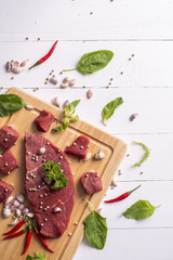 Raw beef on white wood background