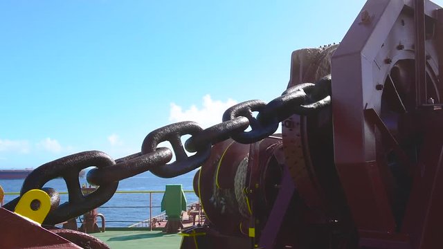 A cargo ship heaving up her anchor