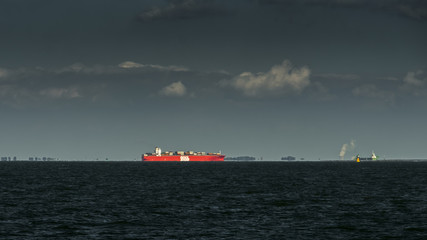 Fototapeta premium Cargo ship arriving from the sea