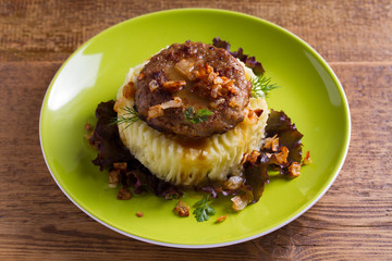 Homemade burger or patty with mashed potato on lettuce