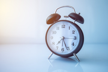 Vintage alarm clock showing almost half past seven in morning