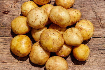 New potatoes on rustic wooden table