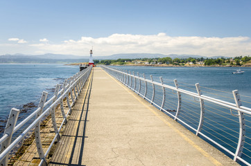 Obraz premium Path on a Breakwater at the Entrance of a Harbour. Victoria, BC, Canada.
