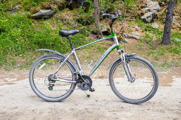 Fototapeta na wymiar Mountainbike Parked on a Gravel bicycle Path