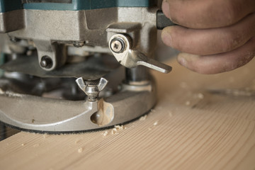 The carpenter mills the countertop made of pine