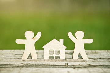 little wooden men and house on natural background. Symbol of construction, family, sweet home concept - 209776138