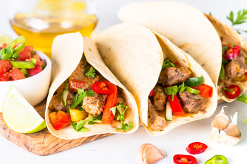 Mexican pork tacos with vegetables and salsa.