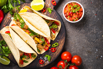 Mexican pork tacos with vegetables and salsa.