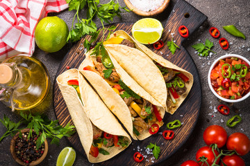 Mexican pork tacos with vegetables and salsa.