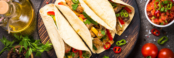 Mexican pork tacos with vegetables and salsa.