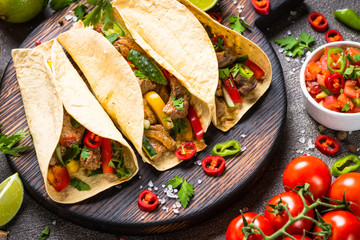 Mexican pork tacos with vegetables and salsa.