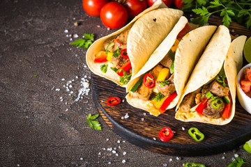 Mexican pork tacos with vegetables and salsa.