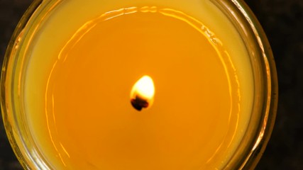 Looking down at a candle burning