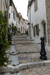 Steps and narrow street in the old town of Arles in Provence in the South of France.