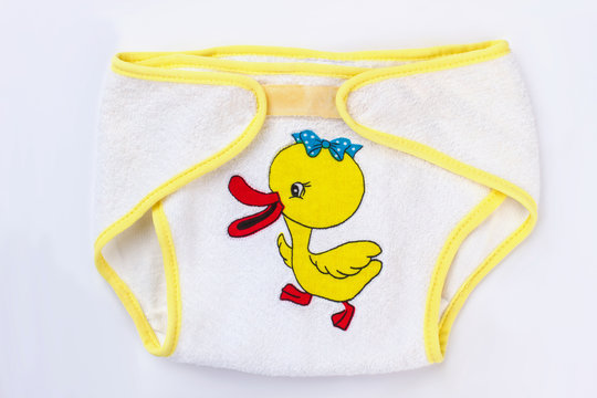 Baby cotton diapers with cartoon duck image, close up.