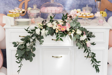 Beautiful sweets on a dresser. Stylish candy bar at a modern wedding.