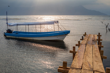 Wooden piers and a boat at lake Yojoa, Honduras