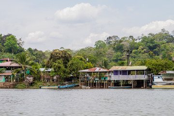Fototapeta na wymiar Riverside houses in Ell Castillo village at San Juan river, Nicaragua