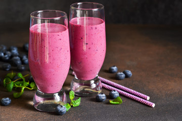 Smoothies with a banana, raspberries and blueberries on a dark background. Detox Drink.