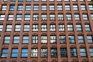 Looking up at the Guaranty Building (Prudential Building) 1896 following Form Follows Function design theory. Clad in terracotta in Buffalo New York. Reflection of a skyscraper in the windows.