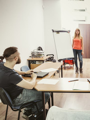 Male Student and teacher tutor in classroom