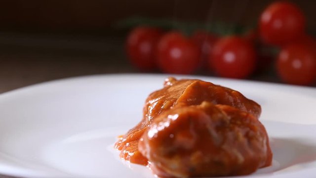  Putting With A Wooden Spoon Meatballs With Tomato Sauce On The White Plate