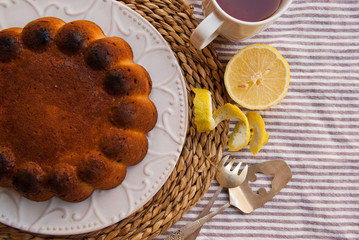 Homemade lemon cake with cup of tea. Food background.